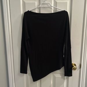 Black, off the shoulder, top. Slightly sheer but not much. Bottom hem is slanted